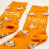 Orange socks with flying pigs over them and the AA logo in white