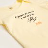 Baby onesie - ecru colour. Pic of a fist, Animals Australia logo and 'Future animal protector.'