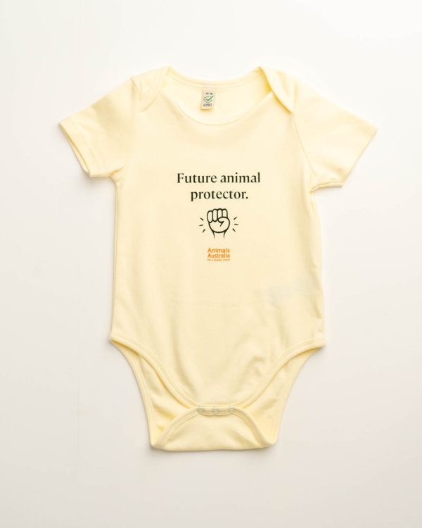 Baby onesie - ecru colour. Pic of a fist, Animals Australia logo and 'Future animal protector.'