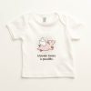 White baby tee with pic of a flying pig on it and the phrase 'A kinder future is possible.'