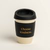 Beige reusable coffee cup with black band and lid. Band printed with 'Choose kindness'